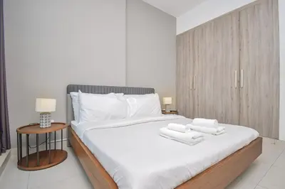 a bedroom with a bed with two towels on it at Elegant 2BR view with rooftop pool The Bay in Dubai