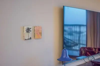 a living room with a mirror and a blue lamp at Burj Al Arab View - 1BR in MJL Lamtara 1- Burj Al Arab View 703 in Dubai