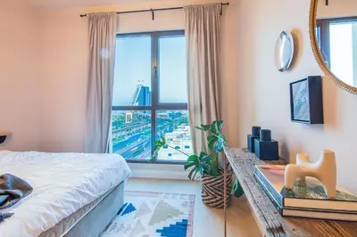 a bedroom with a bed and a large window at Burj Al Arab View - 1BR in MJL Lamtara 1- Burj Al Arab View 703 in Dubai