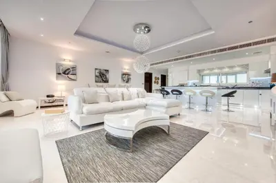 a living room with a white couch and a table at Tiara Residence Ruby, Palm Jumeirah - Mint Stay in Dubai