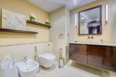a bathroom with a toilet and a sink and a mirror at Tiara Residence Ruby, Palm Jumeirah - Mint Stay in Dubai