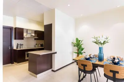 a kitchen and dining room with a table and chairs at Tiara Beach Residences, Palm Jumeirah Dubai - Mint Stay in Dubai