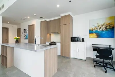 a kitchen with a counter and a chair in a room at Vacay Lettings - Waterfront Luxury home with full Marina view in Dubai
