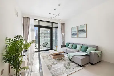 a living room with a couch and a large window at Free Beach Access! Beautiful Palm Jumeirah & Dubai Eye in Dubai