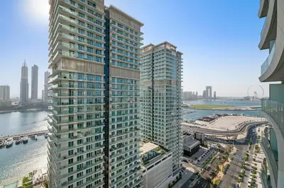 a tall building with a view of the water at Free Beach Access! Beautiful Palm Jumeirah & Dubai Eye in Dubai