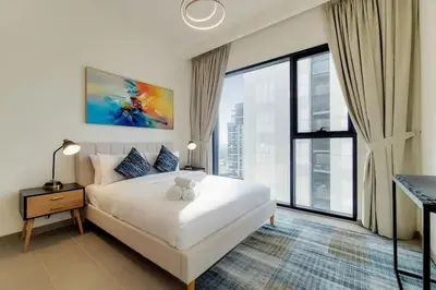 a bedroom with a white bed and a large window at Vacationer I Executive 1 Bedroom I Free Parking & Wi-Fi in Dubai