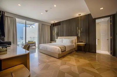a hotel room with a bed and a desk at FIVE Palm Jumeirah 2BR Luxury Penthouse, Private Pool, Full Marina Sea View in Dubai