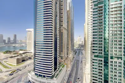 a view of a city with tall buildings at Vacationer I Glamorous 2 Bedroom I Steps from Barasti Beach I Marina Views in Dubai