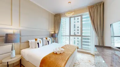 a bedroom with a large bed and a large window at Vacationer I Glamorous 2 Bedroom I Steps from Barasti Beach I Marina Views in Dubai