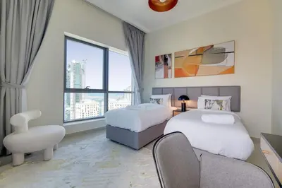 a hotel room with two beds and a window at Bay Central, Central Tower - Tranquil Two Bedroom in Dubai