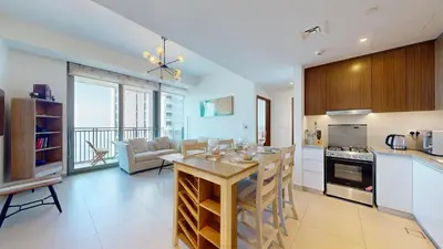 a kitchen and living room with a table in it at 5242 Tower 2 - Light One Bedroom in Dubai