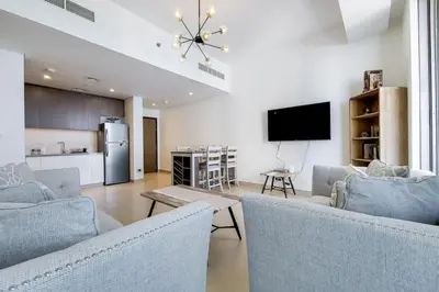 a living room with two couches and a tv at 5242 Tower 2 - Light One Bedroom in Dubai