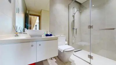 a bathroom with a toilet and a sink and a shower at Stylish Apartment Balcony and Sea Views in Dubai