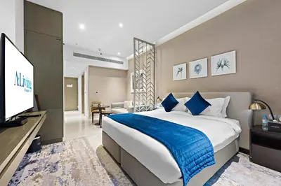 a bedroom with a large bed and a television at ALiving Luxury Studio I DAMAC Maison Prive A- 1007 in Dubai
