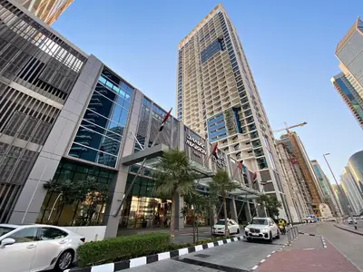 a large building with cars parked in front of it at ALiving Luxury Studio I DAMAC Maison Prive A- 1007 in Dubai