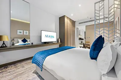 a bedroom with a large white bed with blue pillows at ALiving Luxury Studio I DAMAC Maison Prive A- 1007 in Dubai
