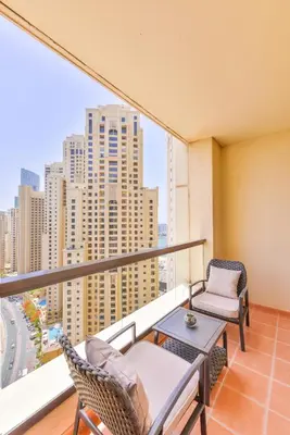 a balcony with chairs and a table and a view of a city at Luxury JBR · Marina View · 5* Beach Resorts Access in Dubai