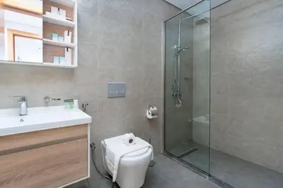 a bathroom with a shower and a toilet and a sink at Perfect 2br for families in JVC in Dubai