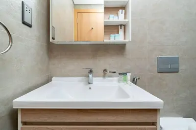 a bathroom with a white sink and a mirror at Perfect 2br for families in JVC in Dubai