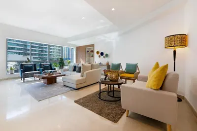 a living room with white furniture and a large window at Maison Privee - Stunning 3-Floor Villa with Kids Room & Rooftop Terrace over Dubai Marina in Dubai