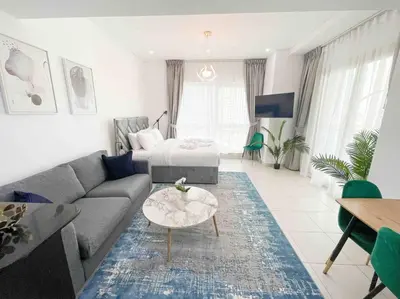 a living room with a couch and a table at Royal Oceanic in JBR by HAPPY SEASON in Dubai