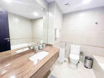 a bathroom with a sink and a toilet and a tub at Royal Oceanic in JBR by HAPPY SEASON in Dubai