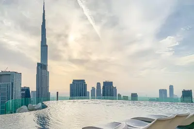 a swimming pool on the roof of a skyscraper with a view of the sh at Frank Porter - Paramount Midtown in Dubai
