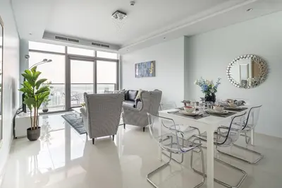 a dining room with a white table and chairs at Frank Porter - Paramount Midtown in Dubai