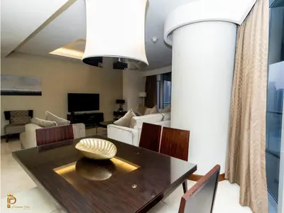 a living room with a table and a couch at Paradise View The Dubai Mall Residences in Dubai