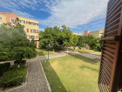 a view of a park with trees and a building at Stylish Studio in Discovery Garden MED100 in Dubai