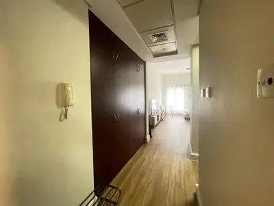 a hallway with a phone on the wall of a room at Stylish Studio in Discovery Garden MED100 in Dubai
