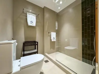 a bathroom with a toilet and a shower at Upgraded 2BR apartment at the beach - Shoreline 1 in Dubai