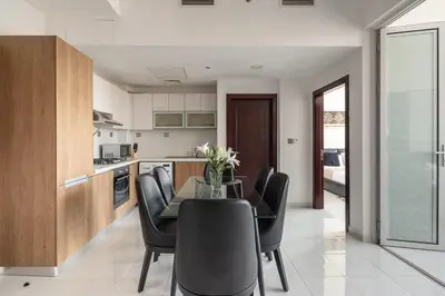 a kitchen and dining room with a table and chairs at Frank Porter - Starz by Danube in Dubai