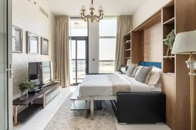 a bedroom with a large bed and a television at Frank Porter - Starz by Danube in Dubai