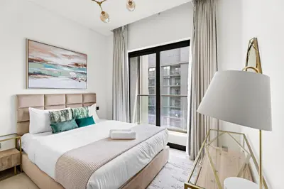 a bedroom with a bed and a large window at New 2 bedroom in Meydan - Green Area in Dubai
