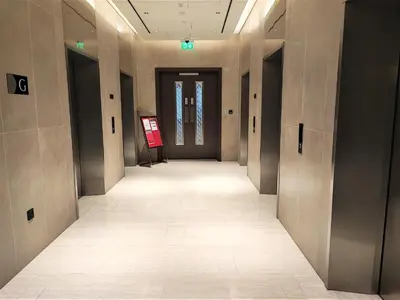 an empty hallway in a building with a sign on the wall at New 2 bedroom in Meydan - Green Area in Dubai