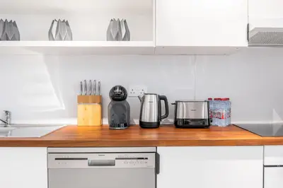 a kitchen with a counter with appliances on it at Ultra Luxury JBR Duplex Penthouse - Free 5 star beach access in Dubai