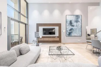 a living room with a couch and a table at Ultra Luxury JBR Duplex Penthouse - Free 5 star beach access in Dubai