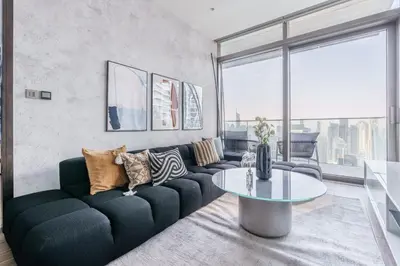a living room with a couch and a table at GuestReady - Luxe Suite in Jumeirah Marina in Dubai