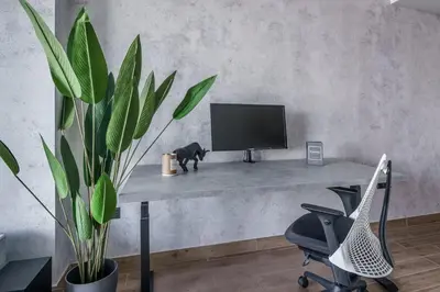 a desk with a computer monitor and a potted plant at GuestReady - Luxe Suite in Jumeirah Marina in Dubai