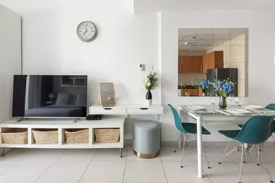 a living room with a table and a dining room at Frank Porter - Marina Views T1 in Dubai