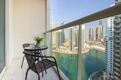 a balcony with a table and chairs and a view of the city at Frank Porter - Marina Views T1 in Dubai