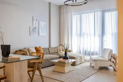a living room with a couch and a table at 2BR Le Pont B3 Full Sea and Pool View in Dubai