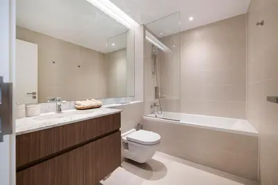 a bathroom with a toilet and a sink and a tub at 2BR Le Pont B3 Full Sea and Pool View in Dubai