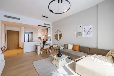a living room with a couch and a table at 2BR Le Pont B3 Full Sea and Pool View in Dubai