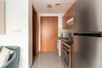a kitchen with a stainless steel refrigerator and a stove at Frank Porter - Lakeside Tower D in Dubai