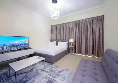 a hotel room with a bed and a couch at RH- Voguish, Studio in Downtown, short walk to Burj Khalifa in Dubai