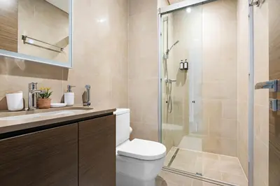 a bathroom with a toilet and a glass shower at Beautiful 2 bedroom next to Business Bay - Sobha Creek Vista in Dubai