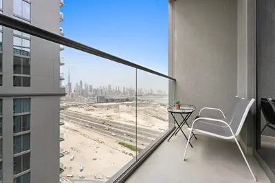 a balcony with a table and a view of a city at Beautiful 2 bedroom next to Business Bay - Sobha Creek Vista in Dubai