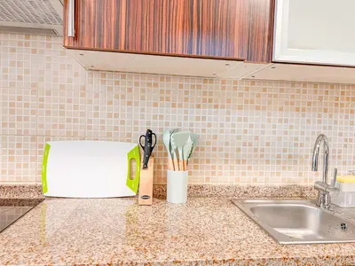 a kitchen counter with a toaster and a sink at Cosmos Living Elegant Studio Near Dubai Marina in Dubai